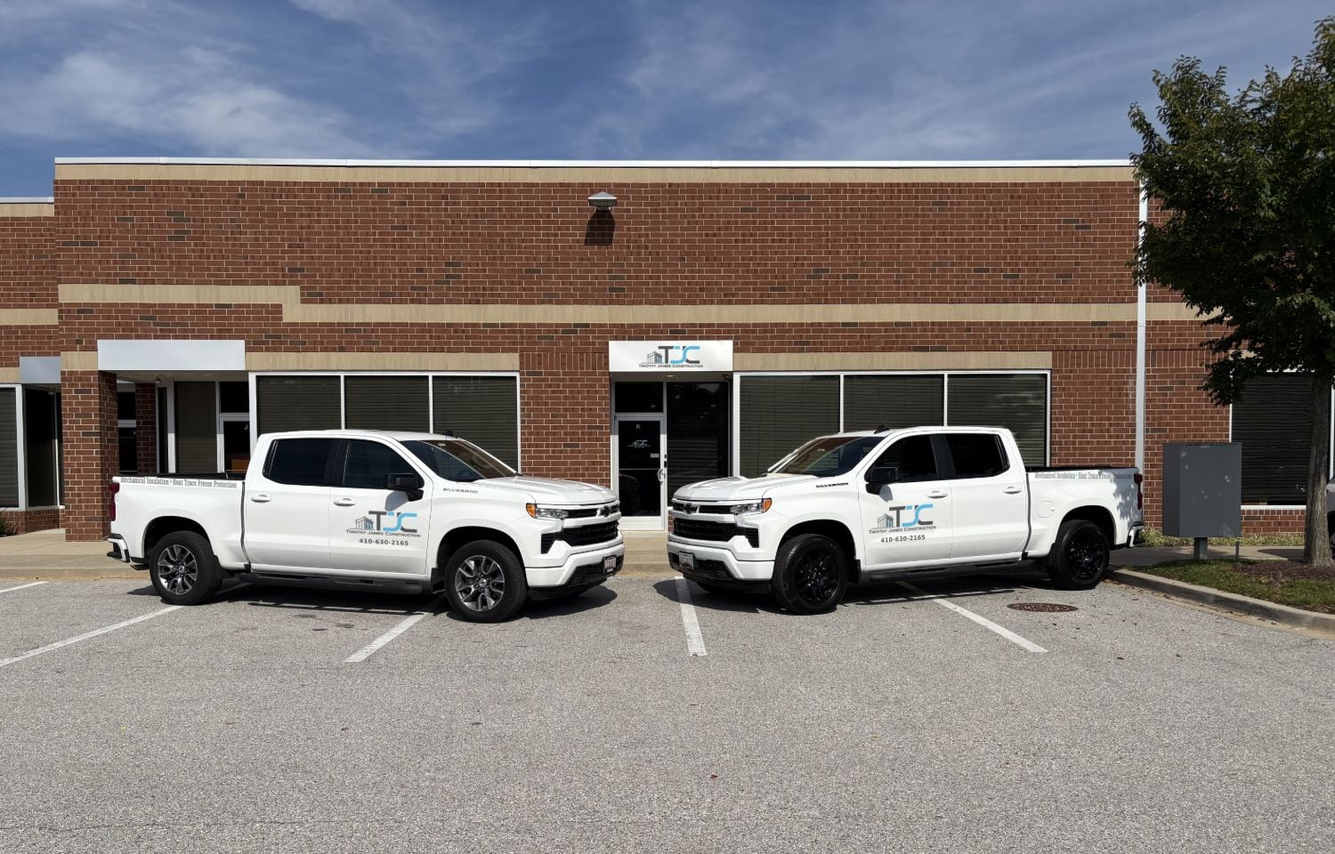 The Timothy James Construction office in Middle River, Maryland, with two company trucks parked outside